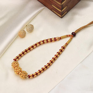 gold bead necklace with red accents