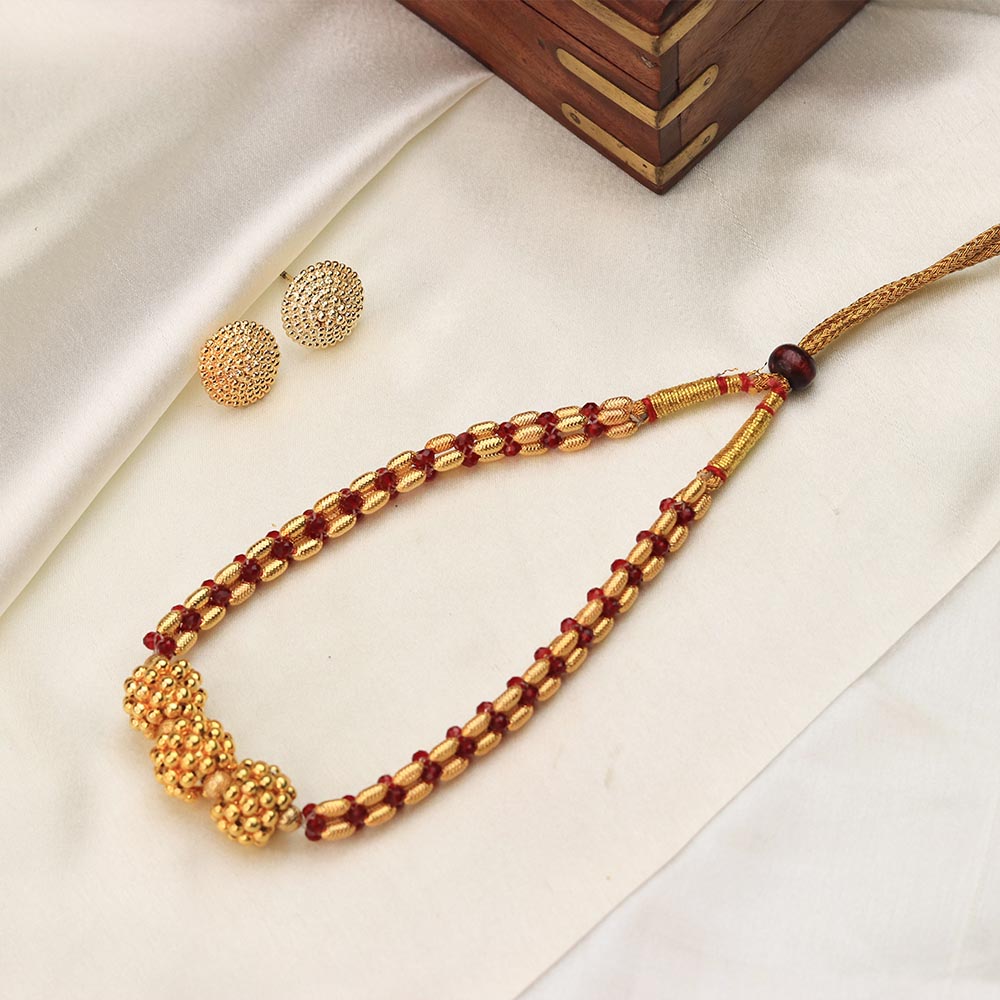 gold bead necklace with red accents