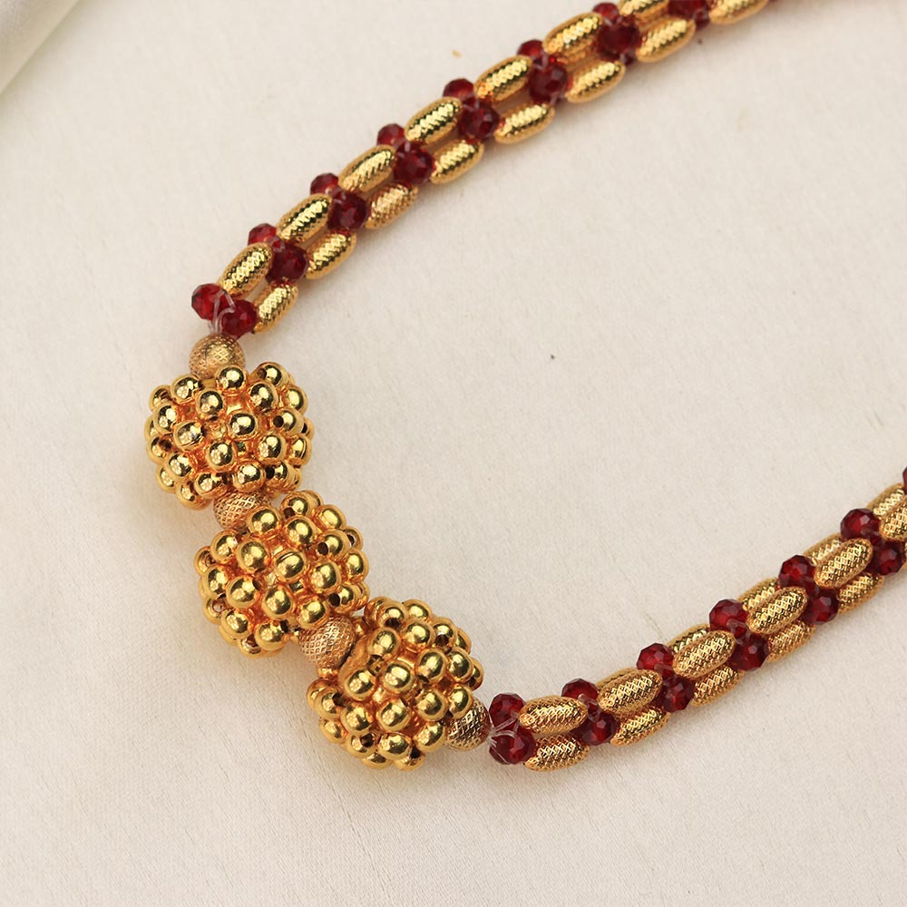 gold bead necklace with red accents