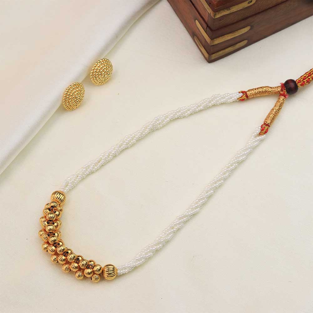 White pearl necklace with gold beads