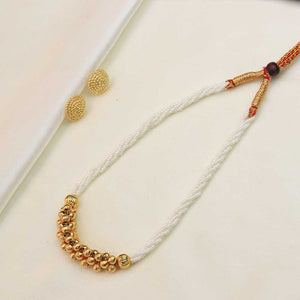 White pearl necklace with gold beads