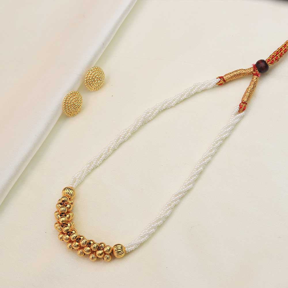 White pearl necklace with gold beads